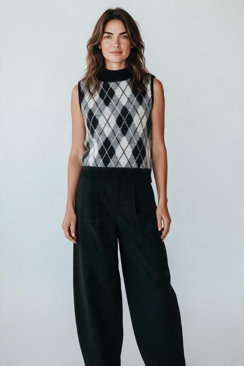 Plaza d'Amanté sleeveless mock-neck sweater vest in a black and grey argyle knit pattern worn by a model.