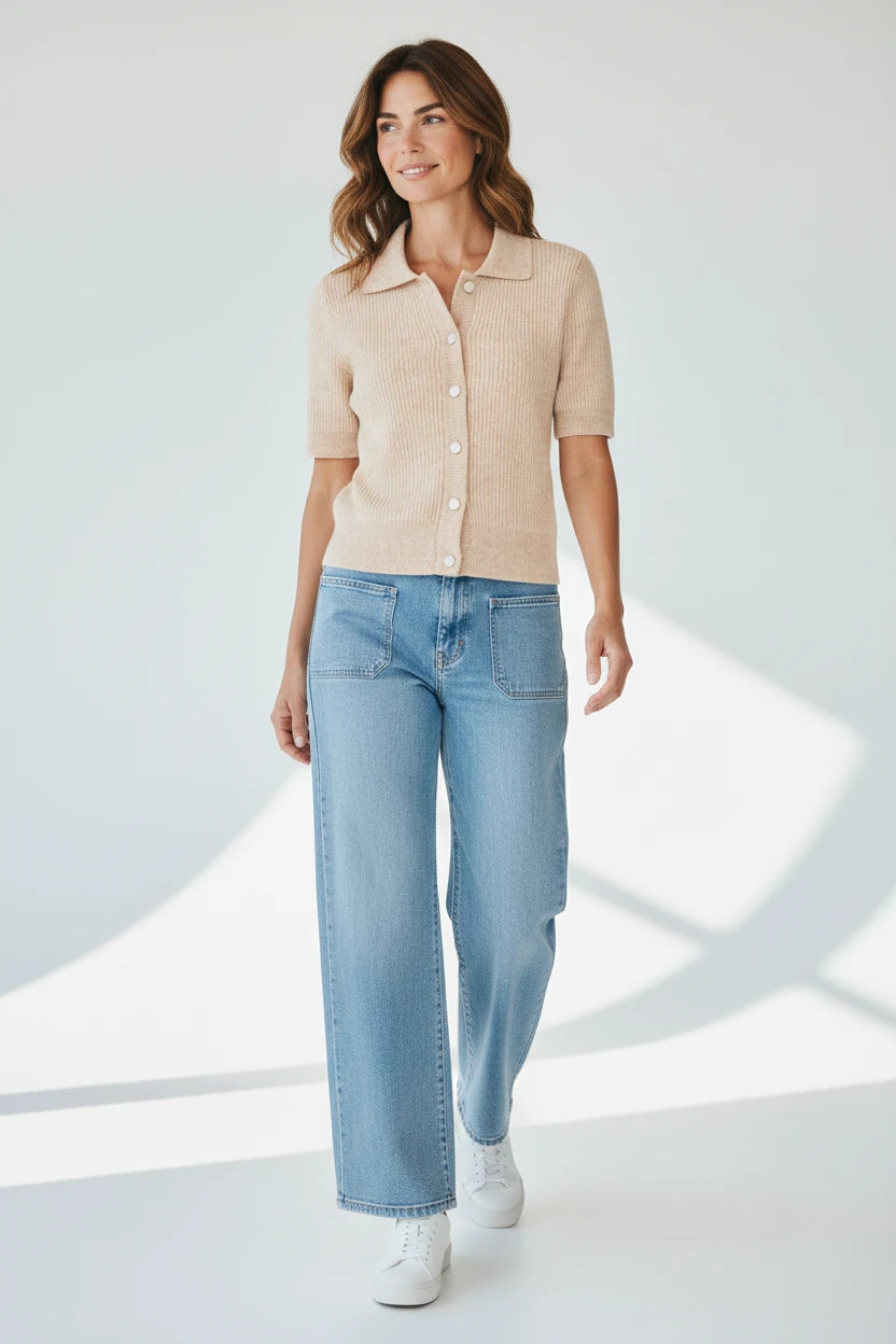 Plaza d'Amanté beige ribbed knit short sleeve polo cardigan with a collared button-down front worn with blue jeans.