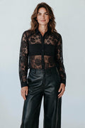 Model wearing a Plaza d'Amanté black floral lace button-down shirt with long sleeves and a structured collar.