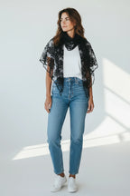 Plaza d'Amanté black floral lace triangle shawl draped over a woman wearing a white t-shirt and blue jeans.