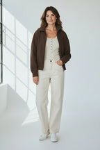 Plaza d'Amanté chocolate brown zip-up bomber jacket worn with high-rise cream denim pants and a henley top
