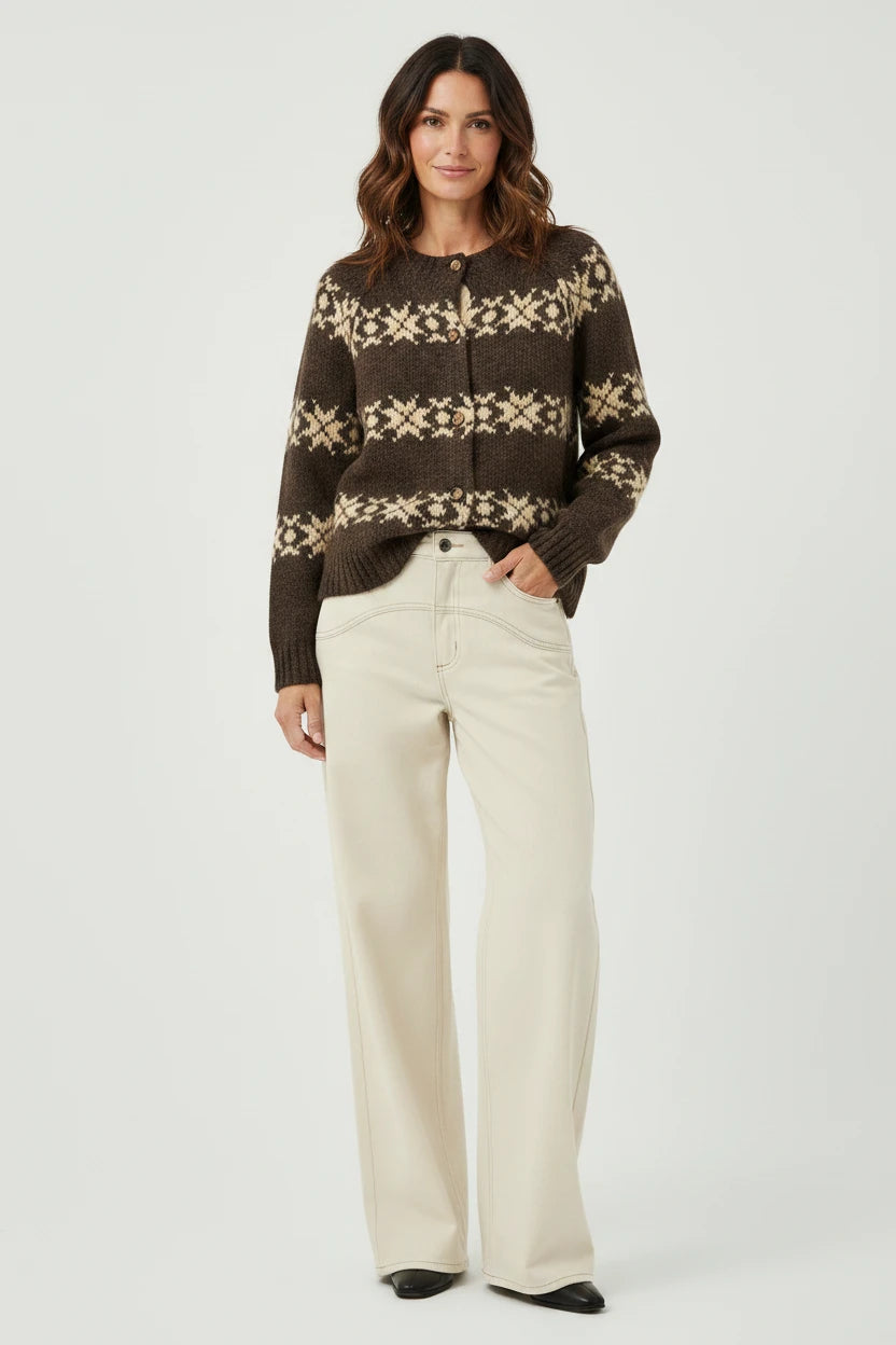 A model wearing a Plaza d'Amanté chocolate brown Fair Isle knit cardigan with cream geometric patterns and buttons.