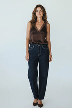 Plaza d'Amanté chocolate brown satin camisole with lace trim V-neck worn by a woman with dark denim jeans
