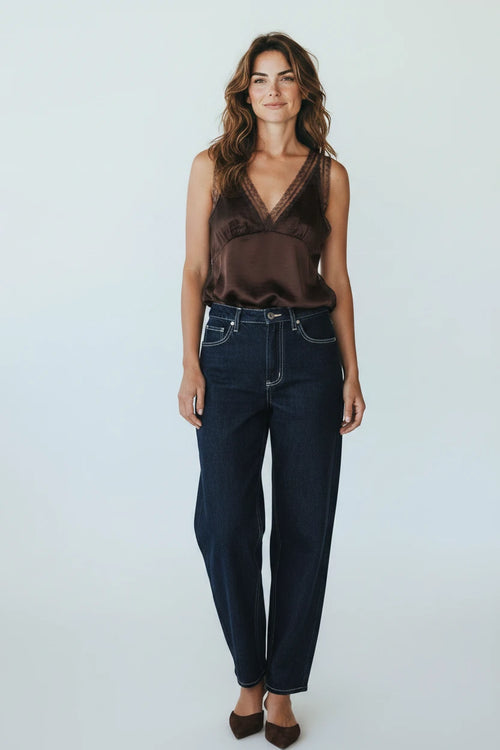 Plaza d'Amanté chocolate brown satin camisole with lace trim V-neck worn by a woman with dark denim jeans