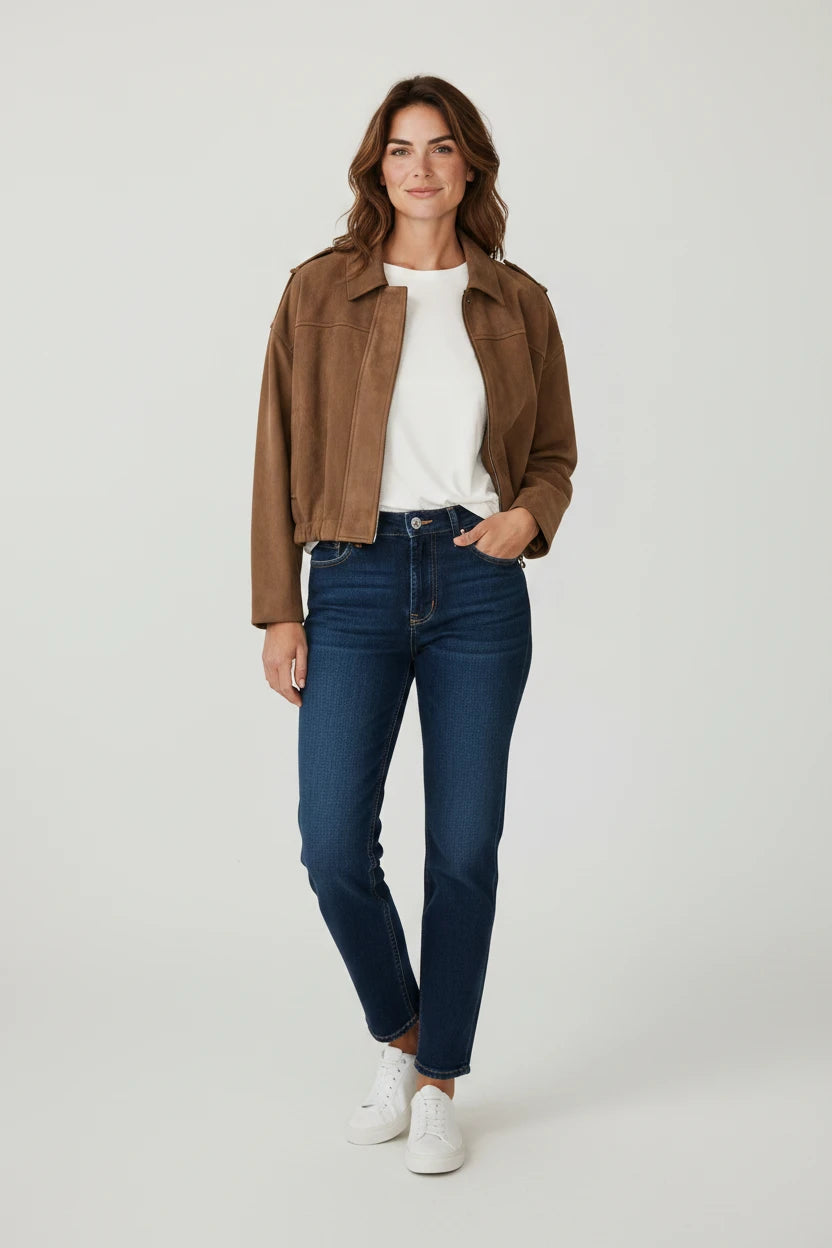 Plaza d'Amanté brown faux suede zip-up jacket worn by a woman with dark denim jeans and white sneakers