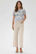 Plaza d'Amanté outfit featuring a blue and cream floral crochet top paired with beige high-rise wide-leg trousers.