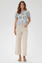 Plaza d'Amanté outfit featuring a blue and cream floral crochet top paired with beige high-rise wide-leg trousers.
