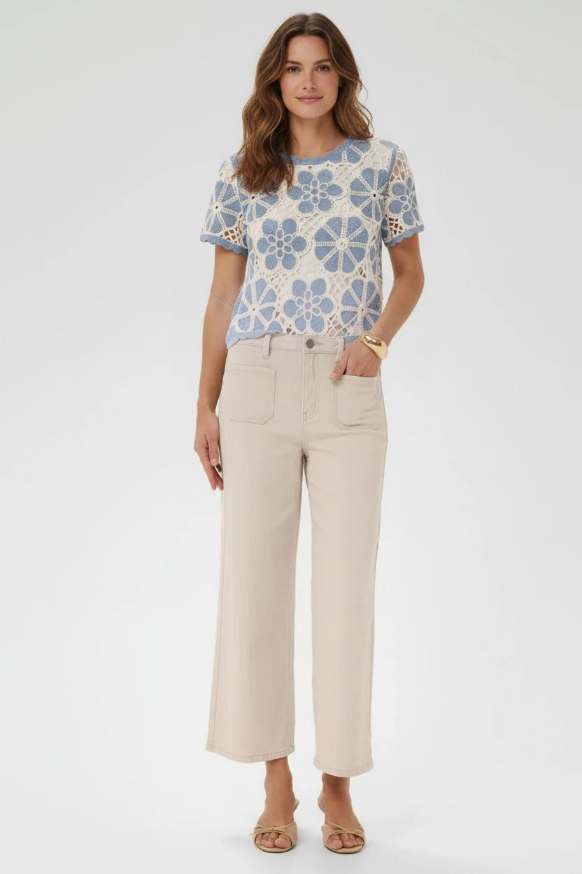Plaza d'Amanté outfit featuring a blue and cream floral crochet top paired with beige high-rise wide-leg trousers.
