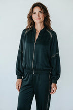 Plaza d'Amanté dark emerald satin bomber jacket with delicate lace shoulder inserts and a zip-front closure.