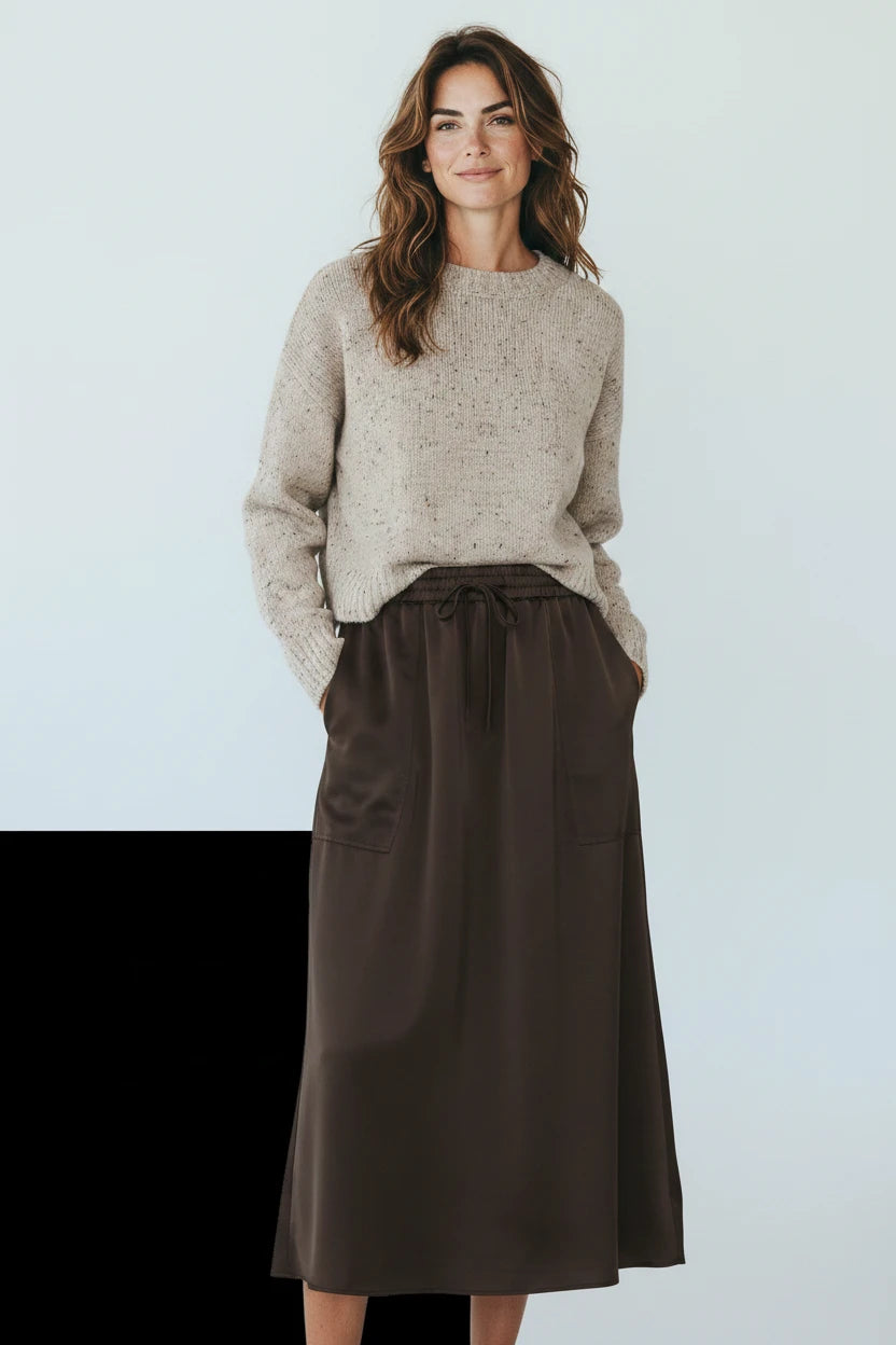 Plaza d'Amanté espresso brown midi skirt with elastic drawstring waist and side pockets worn with a beige sweater.