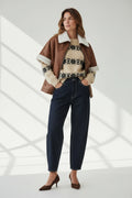 Plaza d'Amanté high waisted relaxed fit dark wash denim trousers worn with a brown faux leather shearling cape jacket