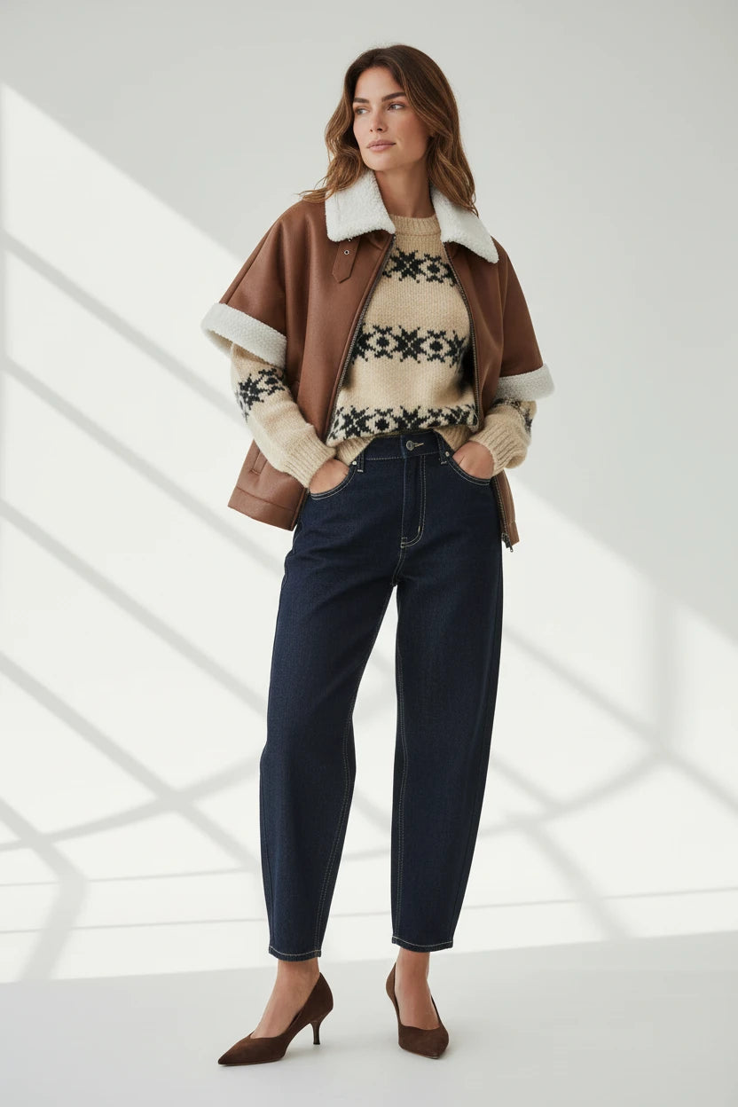 Plaza d'Amanté high waisted relaxed fit dark wash denim trousers worn with a brown faux leather shearling cape jacket