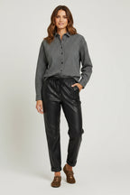 Plaza d'Amanté houndstooth button-down shirt paired with black faux leather joggers on a model