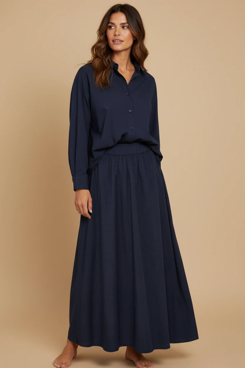 Plaza d'Amanté navy two-piece set featuring a relaxed long-sleeve button-down shirt and a high-waisted maxi skirt.