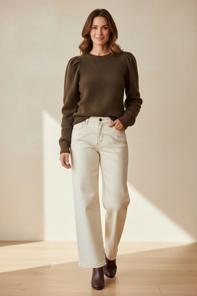 Plaza d'Amanté olive-brown textured knit sweater with puff sleeves paired with off-white wide-leg trousers on a model.