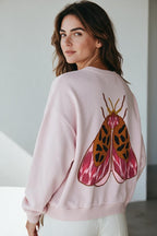Plaza d'Amanté pastel pink cotton-blend pullover sweatshirt featuring a detailed moth graphic print on the back.