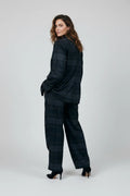 Model wearing a Plaza d'Amanté charcoal and midnight blue plaid tailored blazer and wide-leg trouser suit set.