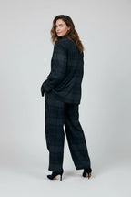Model wearing a Plaza d'Amanté charcoal and midnight blue plaid tailored blazer and wide-leg trouser suit set.