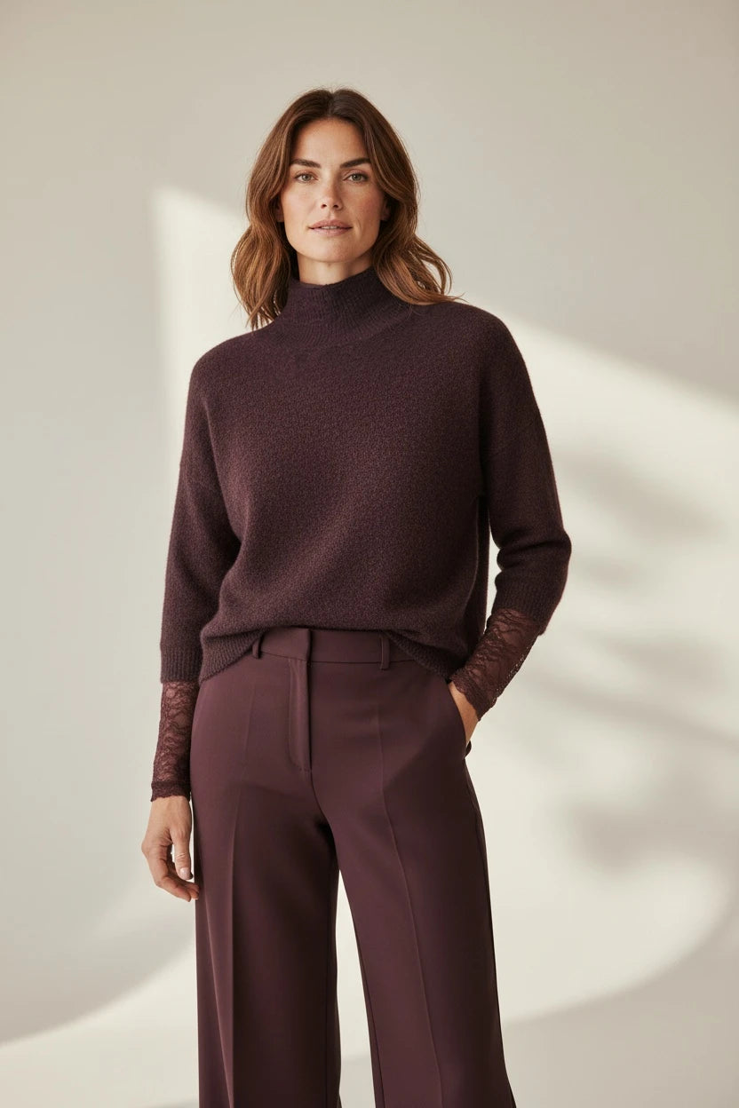 Plaza d'Amanté plum mock neck sweater featuring three-quarter sleeves with delicate lace cuffs worn with trousers.