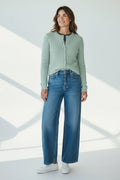 Plaza d'Amanté sage green fuzzy button-front cardigan worn with blue wide-leg jeans and white sneakers