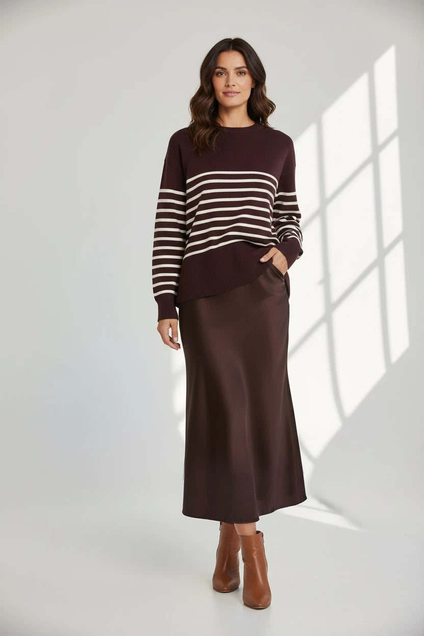 Plaza d'Amanté espresso striped knit sweater and matching chocolate brown satin midi skirt worn by a model.