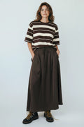 Plaza d'Amanté model wearing a chocolate brown and cream striped t-shirt with a matching brown maxi skirt and boots.