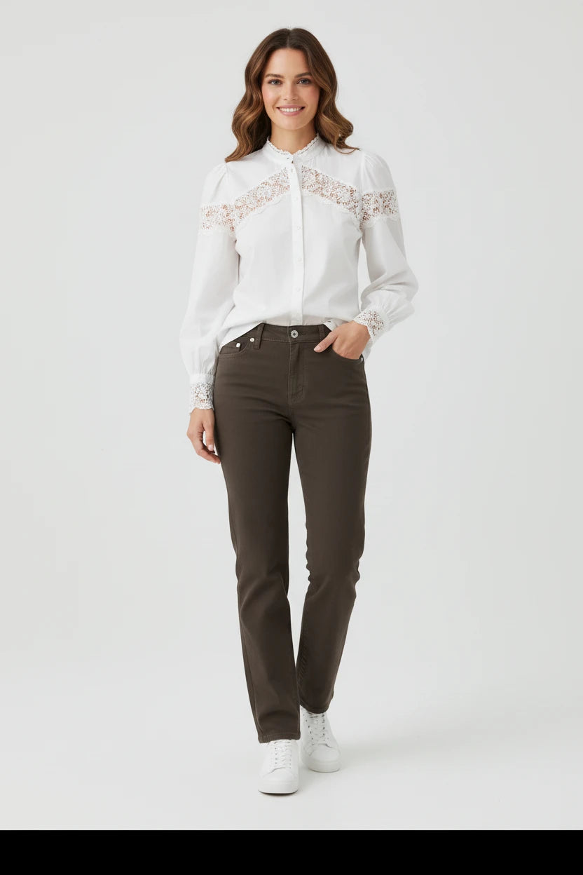Plaza d'Amanté white long sleeve blouse with lace chest and cuff detail worn with dark trousers and white sneakers