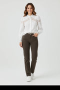 Plaza d'Amanté white long sleeve blouse with lace chest and cuff detail worn with dark trousers and white sneakers
