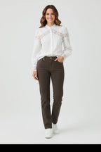 Plaza d'Amanté white long sleeve blouse with lace chest and cuff detail worn with dark trousers and white sneakers