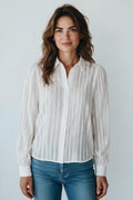 Plaza d'Amanté white long sleeve button-down blouse with vertical stripes and subtle puff shoulders on a model