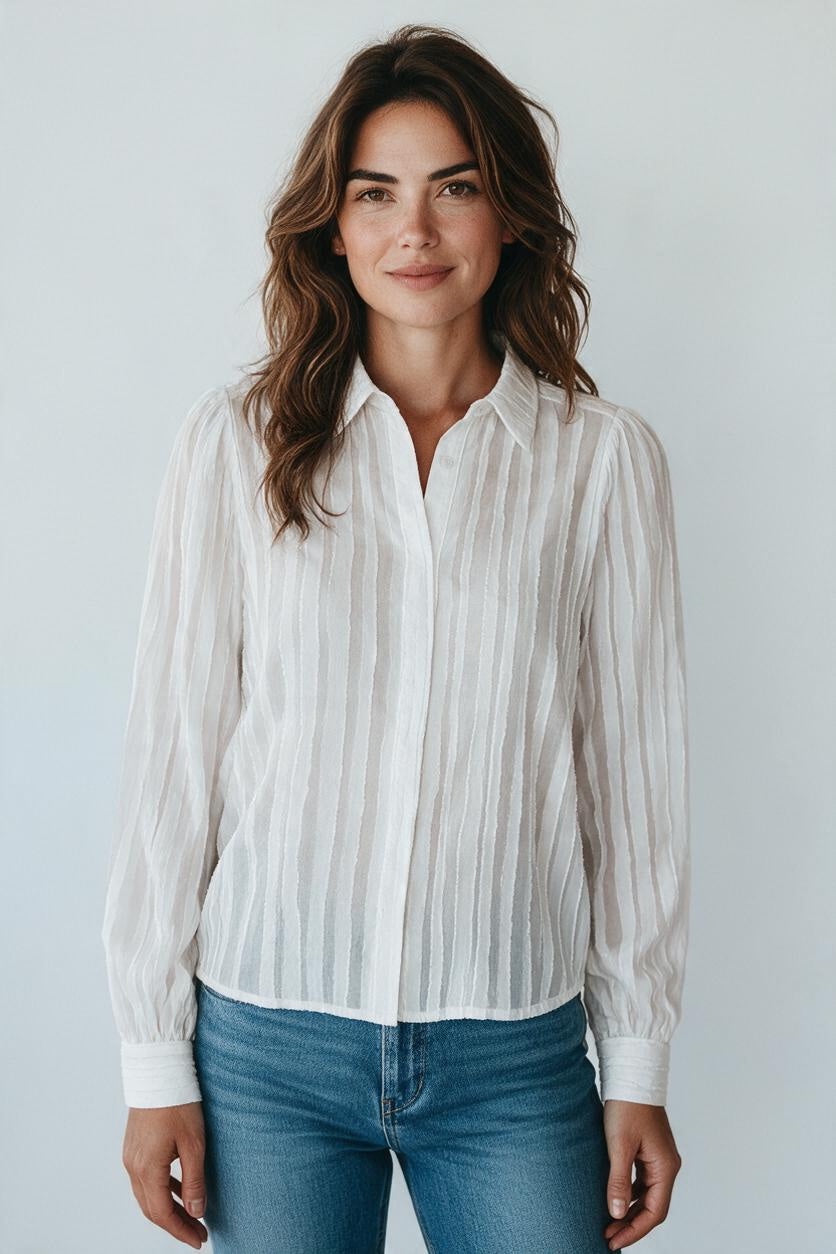 Plaza d'Amanté white long sleeve button-down blouse with vertical stripes and subtle puff shoulders on a model